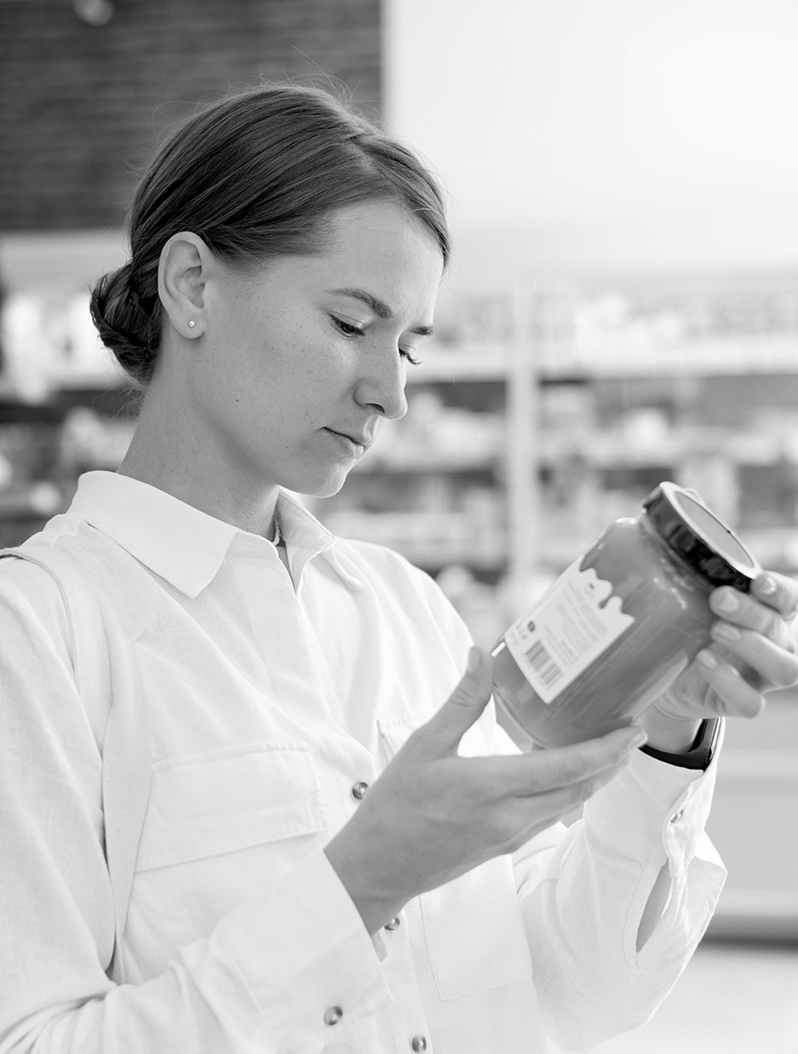 medium shot woman reading label shop